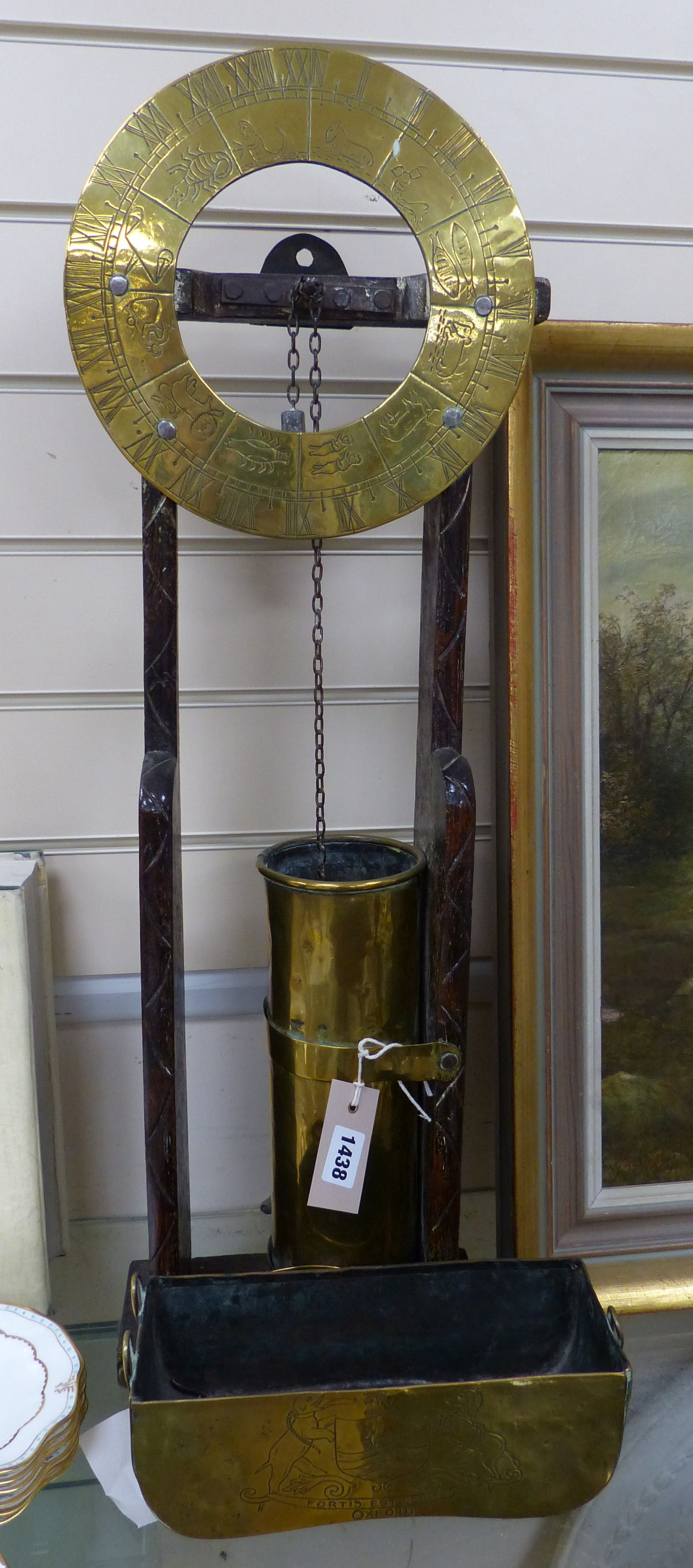 A 17th century style oak and brass 'Clepsydra' or water clock